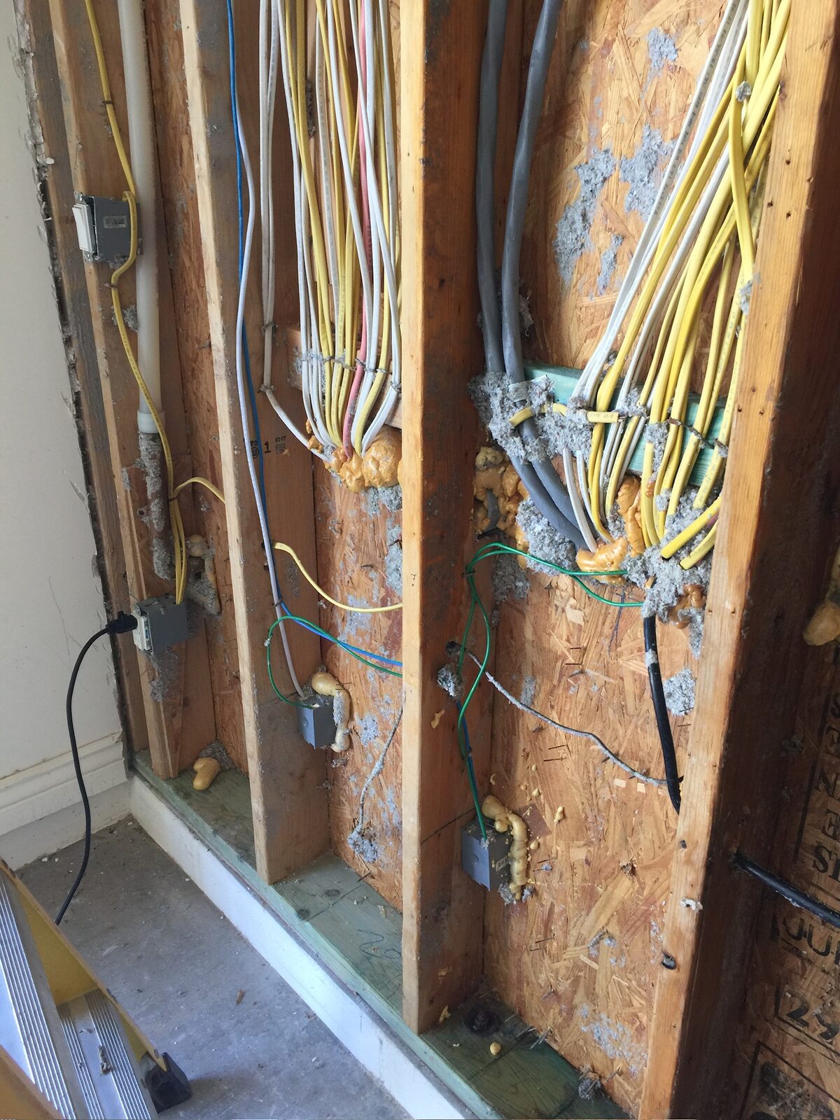 Electrical cables and junction boxes exposed in an open framed wall