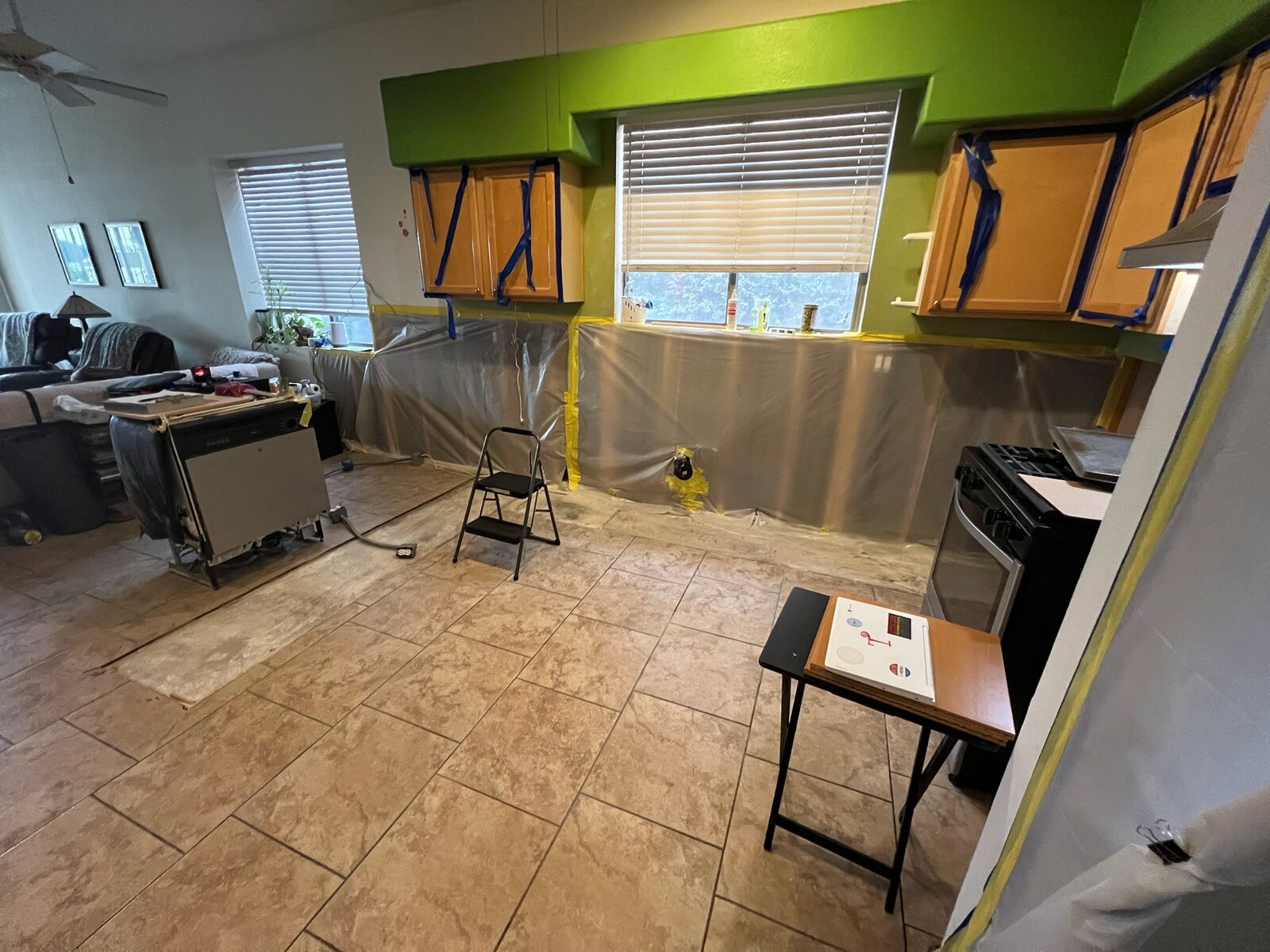 Kitchen counters and walls covered with plastic sheeting before repair work