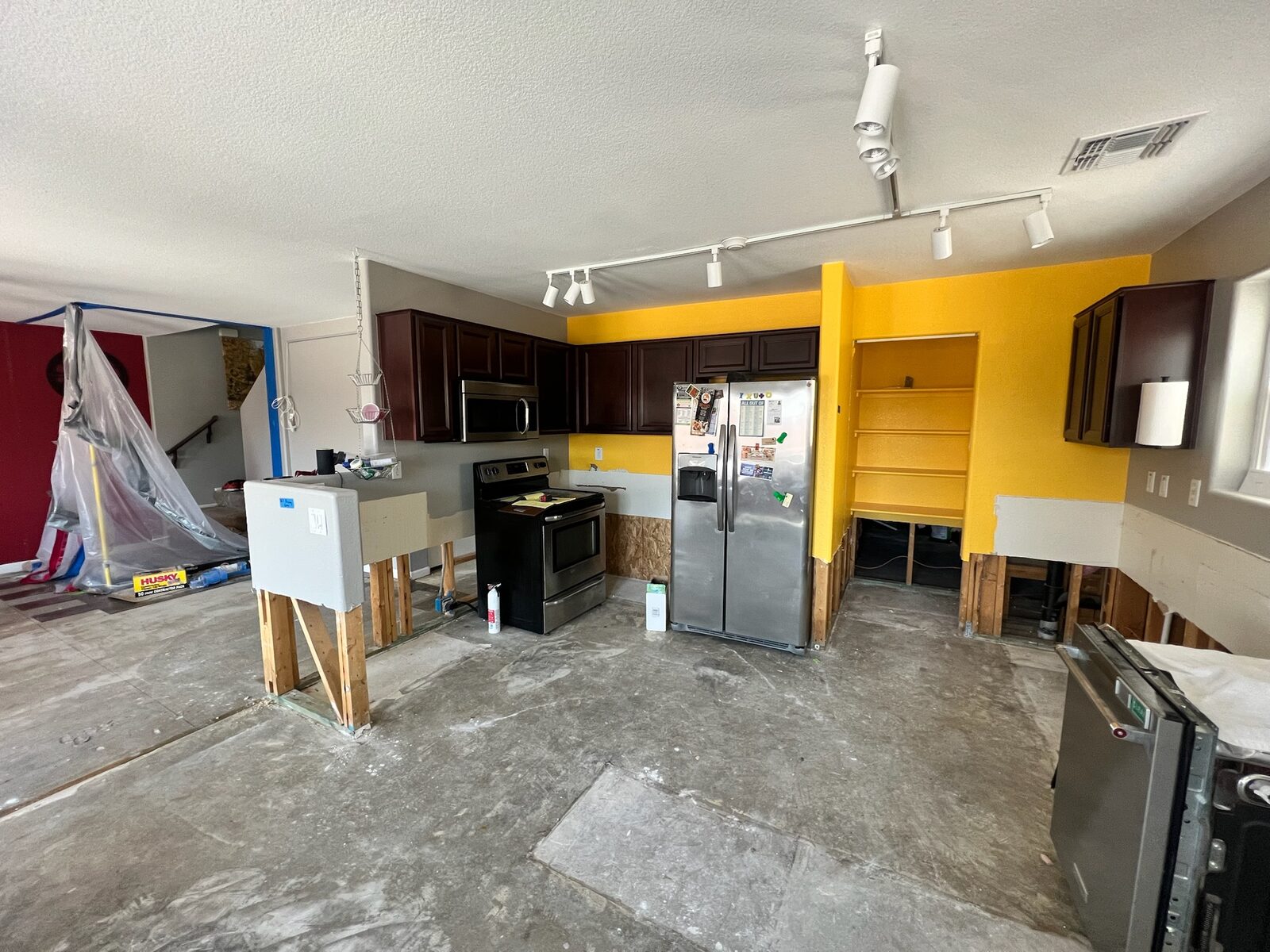 Kitchen during demolition with lower cabinets removed and flood cuts along the walls