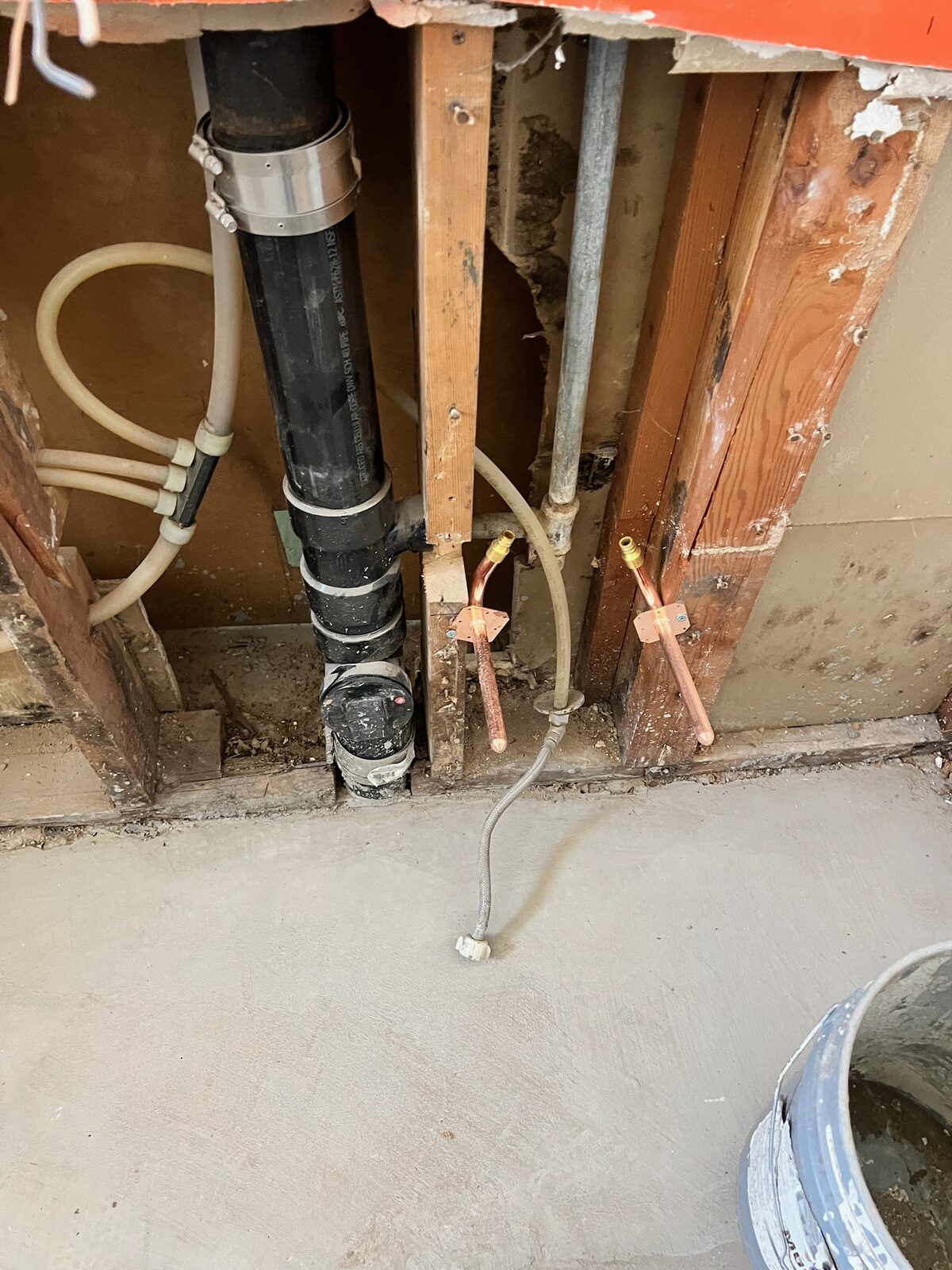 New copper stub outs and drain lines in an open wall during plumbing rough in