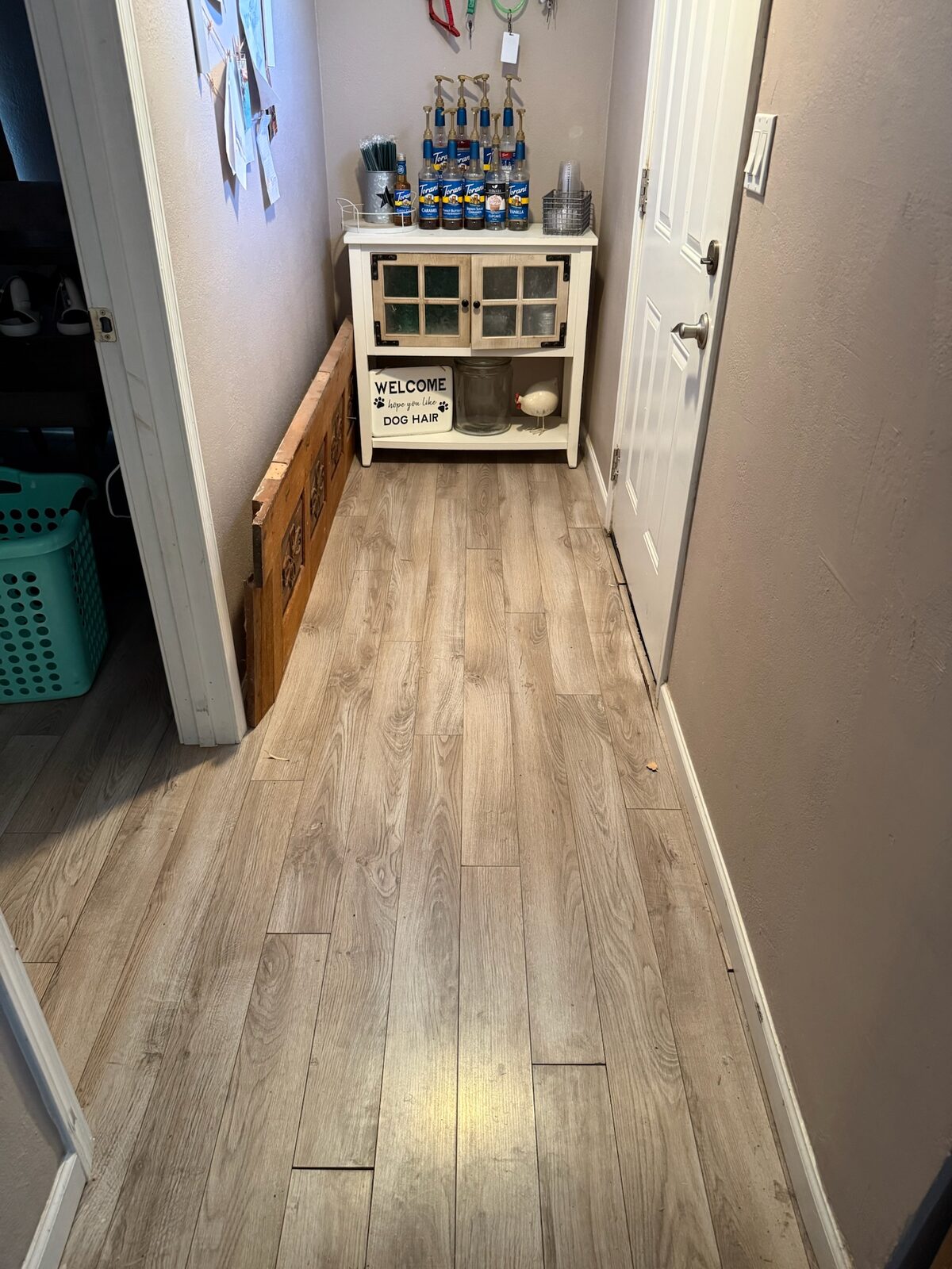 New wood look laminate plank flooring installed in a hallway