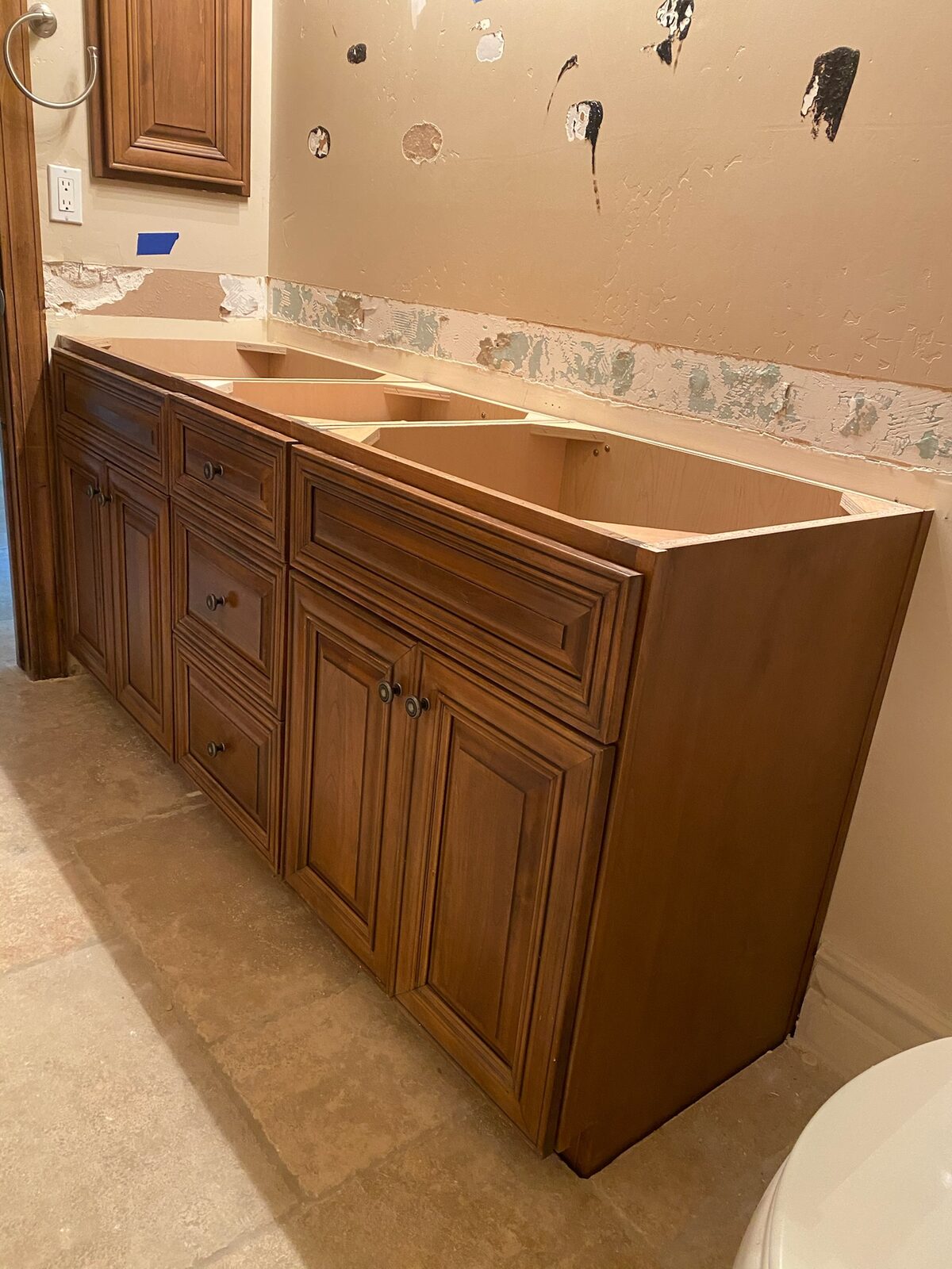 Wood vanity cabinets set in place before countertop installation in a bathroom