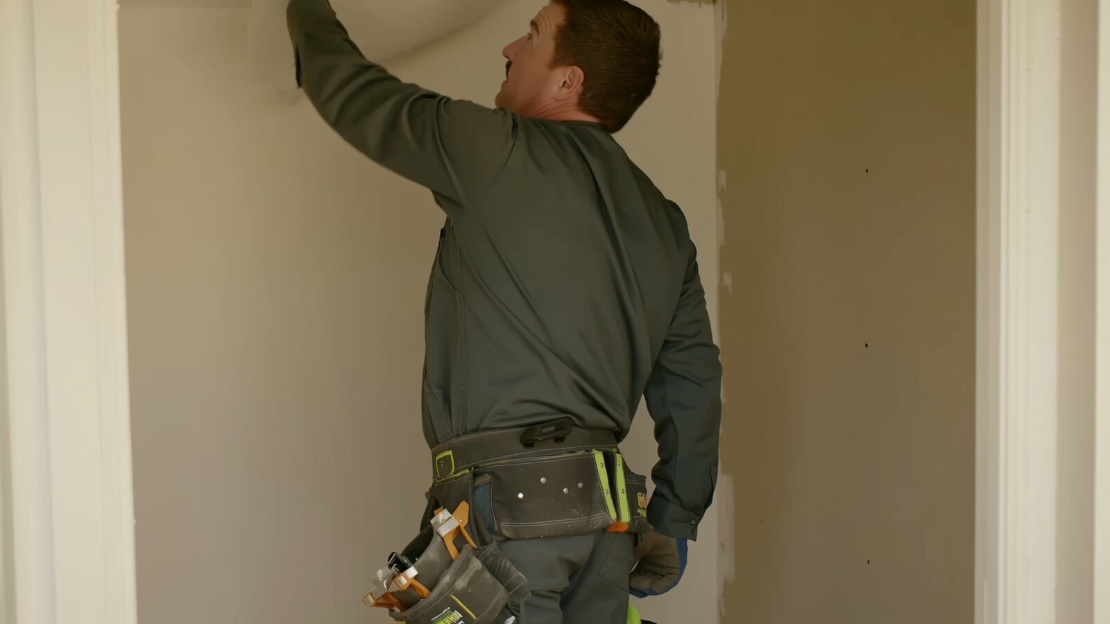 Restoration technician illustrating: Drywall finishing levels: why the same wall can be priced five ways